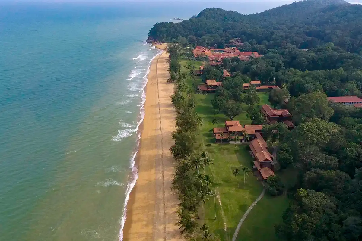 Aerial view of Club Med Cherating beside the beach and forested coastline in Cherating, Pahang