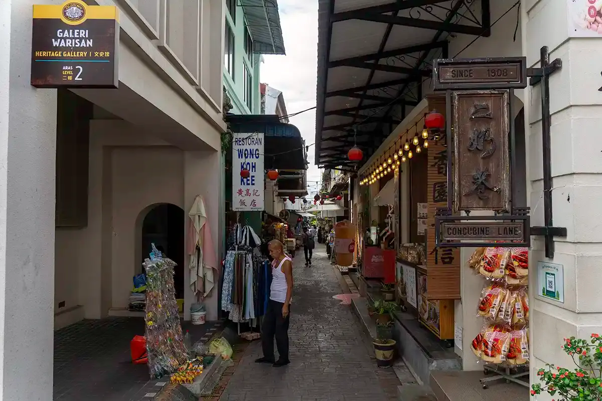 Concubine Lane in Ipoh Old Town with shops, pedestrians and heritage buildings