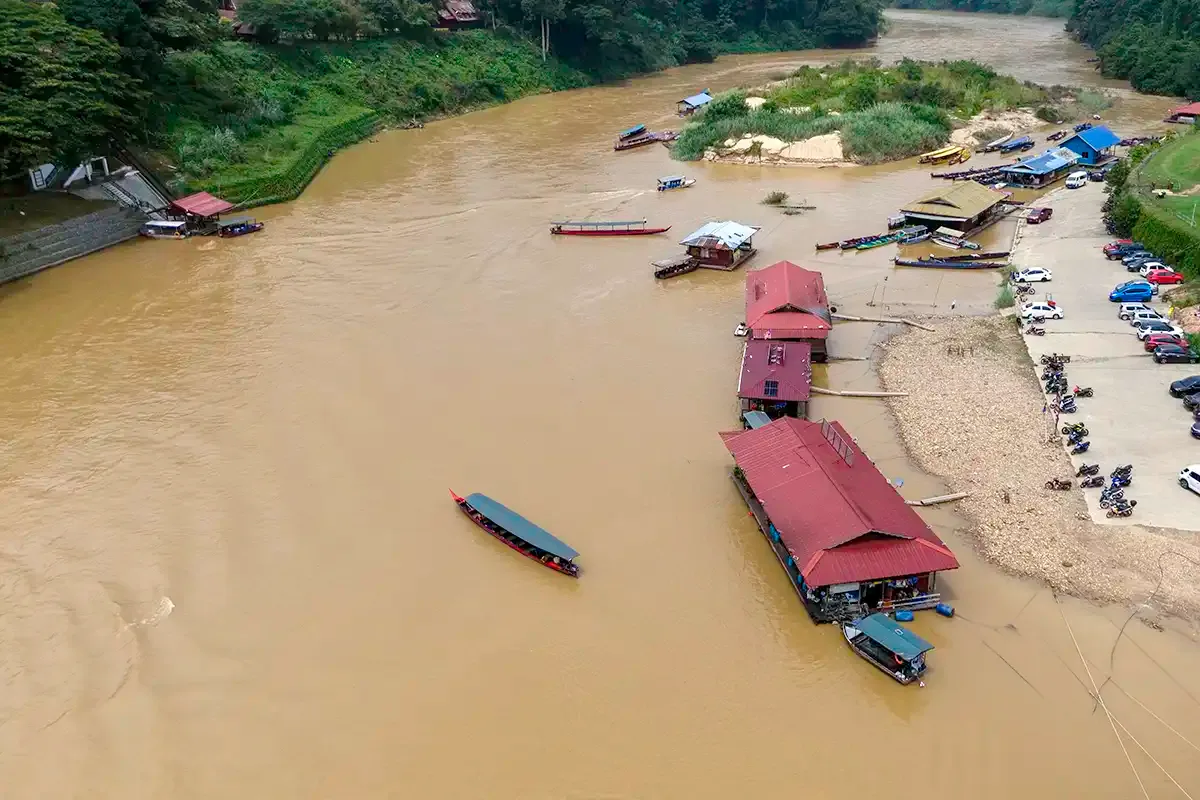 Aerial view of Kuala Tahan riverside with boats and buildings at Taman Negara