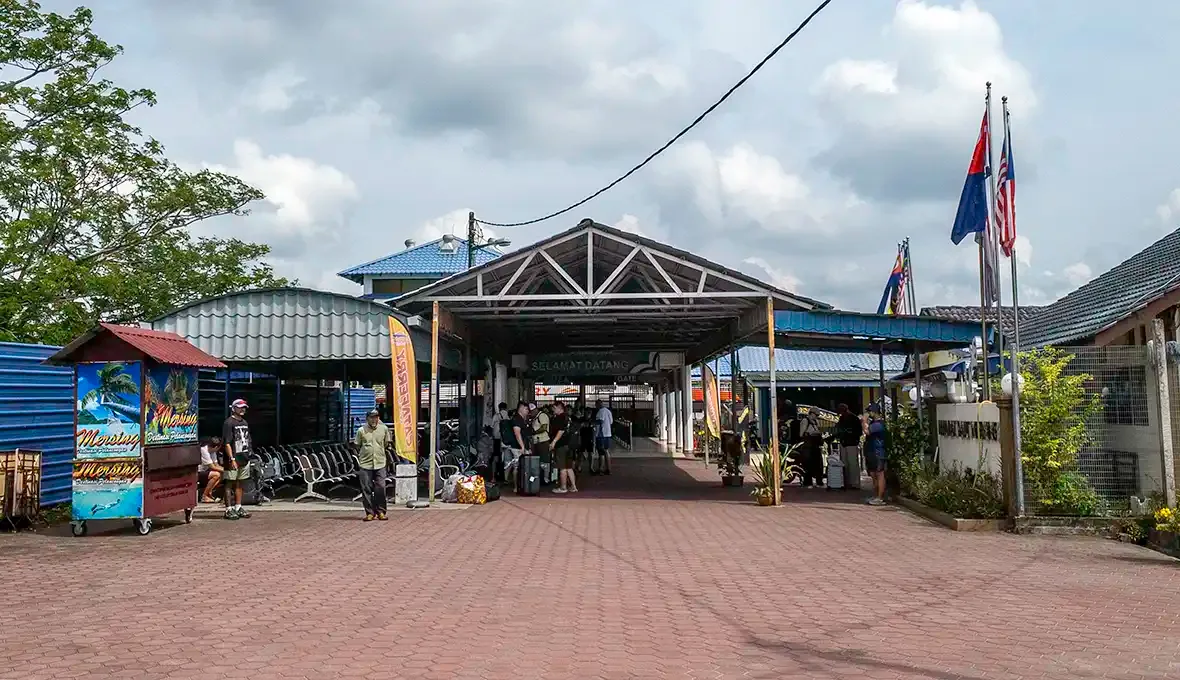 Front entrance of Mersing Jetty with travellers waiting near the ferry terminal in Mersing, Johor