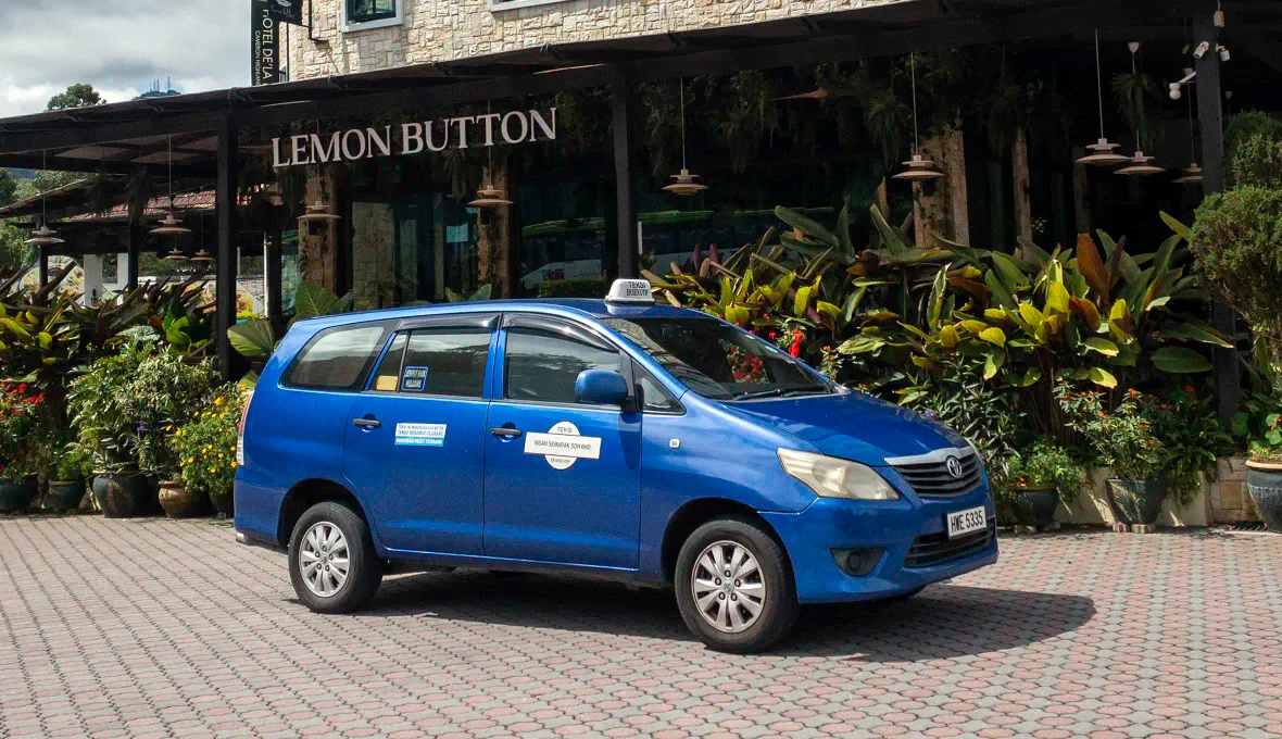 Blue My Little Taxi Toyota Innova MPV parked outside Lemon Button in Cameron Highlands.